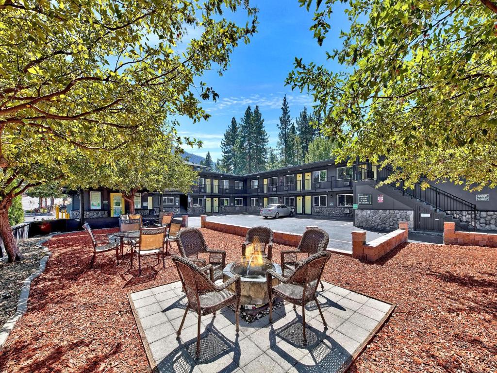 a patio with chairs and a table in front of a house at Secrets Inn Lake Tahoe in South Lake Tahoe