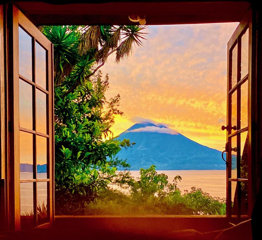 an open window with a view of a mountain at Unique Architecture, Breathtaking views of Lake in Santa Cruz La Laguna