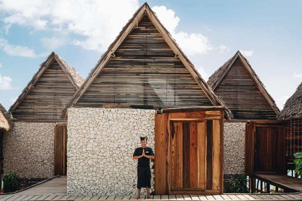 a man standing in front of a building at Paduppa Resort in Bira
