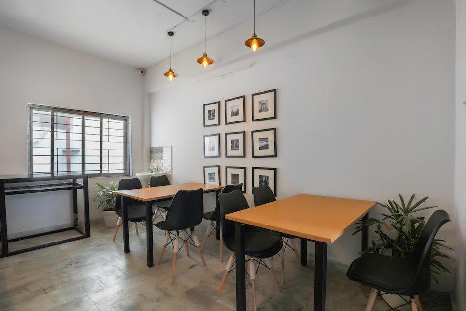 a dining room with two tables and chairs at ELITE ROOMS in Hyderabad