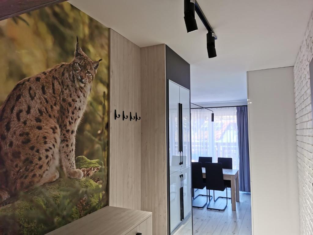 a painting of a lynx on a wall in a room at Apartament Ryś in Szklarska Poręba