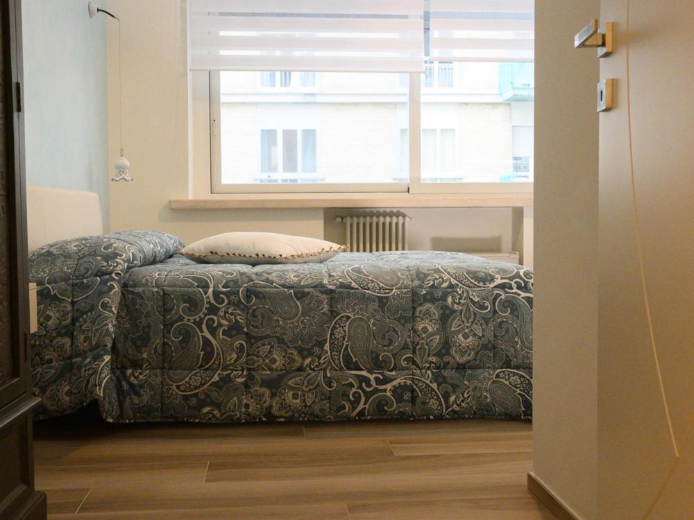 a bed in a room with a window and a bed sidx sidx sidx at RosAmar in Bari