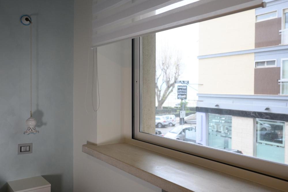 a window in a room with a wooden window sill at RosAmar in Bari