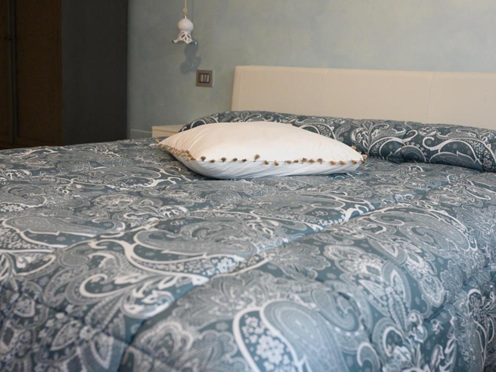 a pillow sitting on top of a bed at RosAmar in Bari