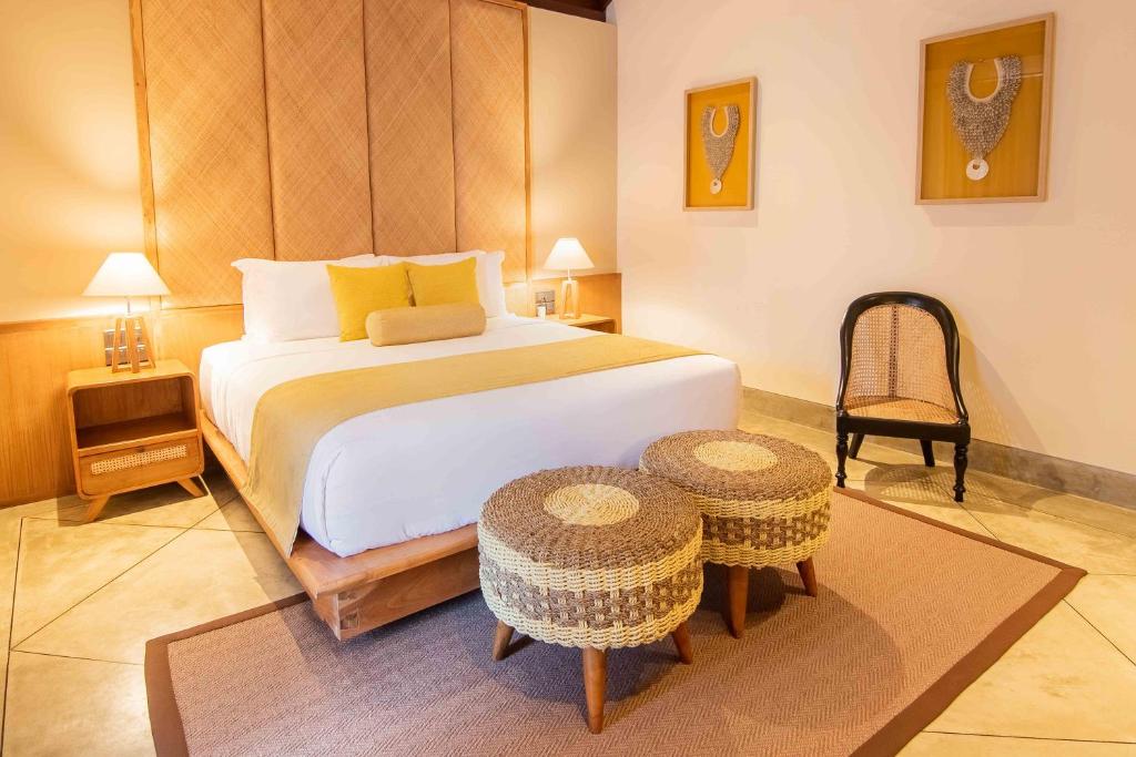 a bedroom with a large bed and a table at The Merchant in Galle