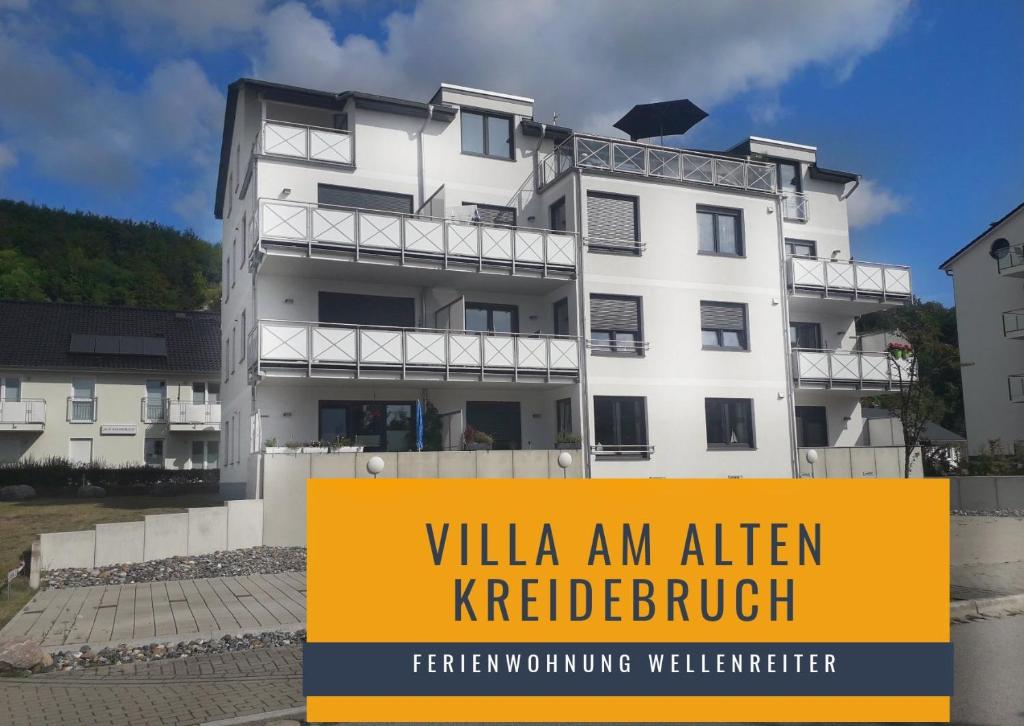 a building with a yellow sign in front of it at Ferienwohnung Wellenreiter in Sassnitz