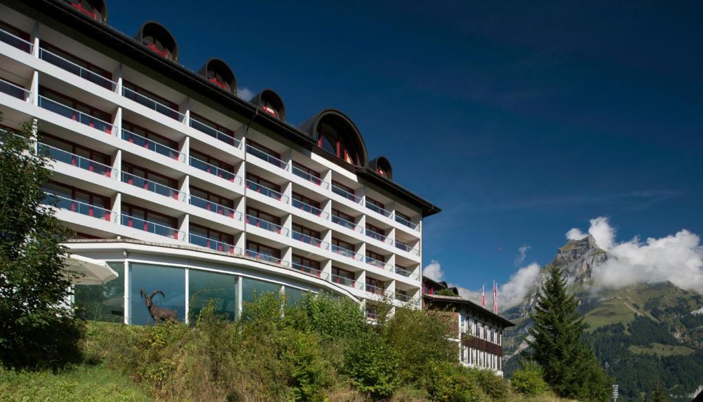 a hotel with a deer in the windows of it at Hotel Waldegg - Adults only in Engelberg