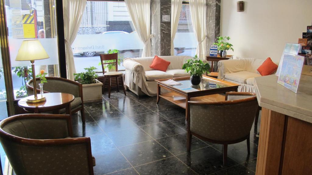 a living room filled with furniture and a table at Hotel Parlamento in Buenos Aires