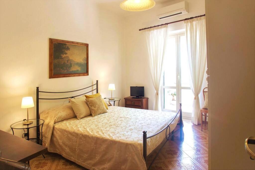 a bedroom with a large bed and a window at L'eco delle sirene in Amalfi