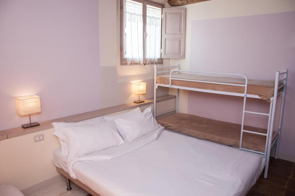 Postel nebo postele na pokoji v ubytování Relais Casetta56