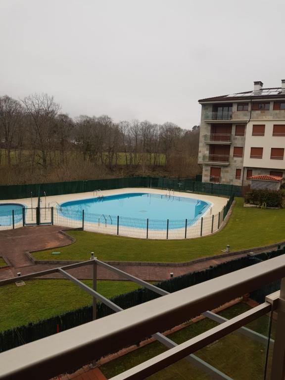 a view of a swimming pool from a building at Apartamento La Esperanza in Cangas de Onís