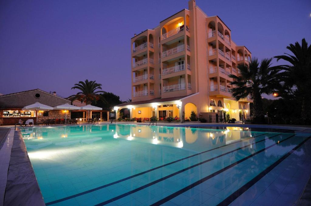a large swimming pool in front of a building at Sunset Hotel in Corfu