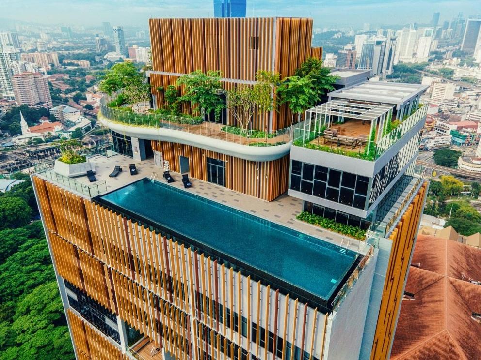 a building with a swimming pool on top of it at Ceylonz Starlight Suites Bukit Bintang in Kuala Lumpur