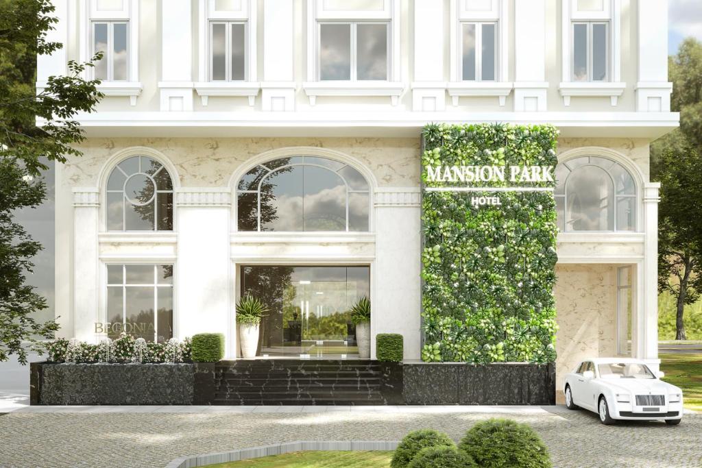 a white car parked in front of a building at Mansion Park Hotel & Apartment in Bien Hoa