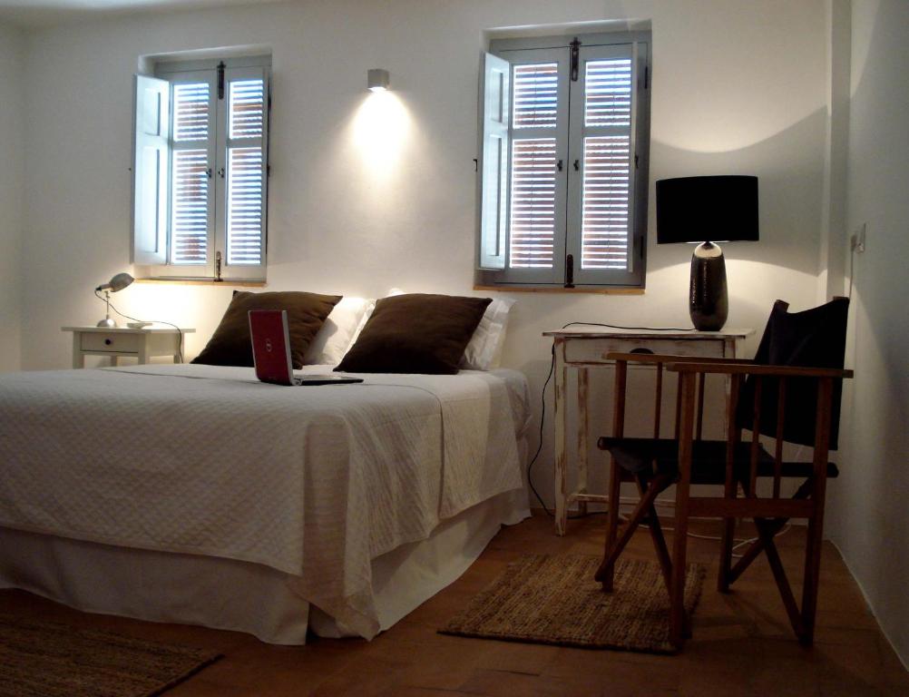 a bedroom with a bed with a laptop on it at Casa Aldomar in Xàtiva