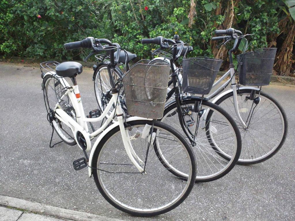 two bikes parked next to each other on a street at Guest House Miyakojima in Miyako-jima