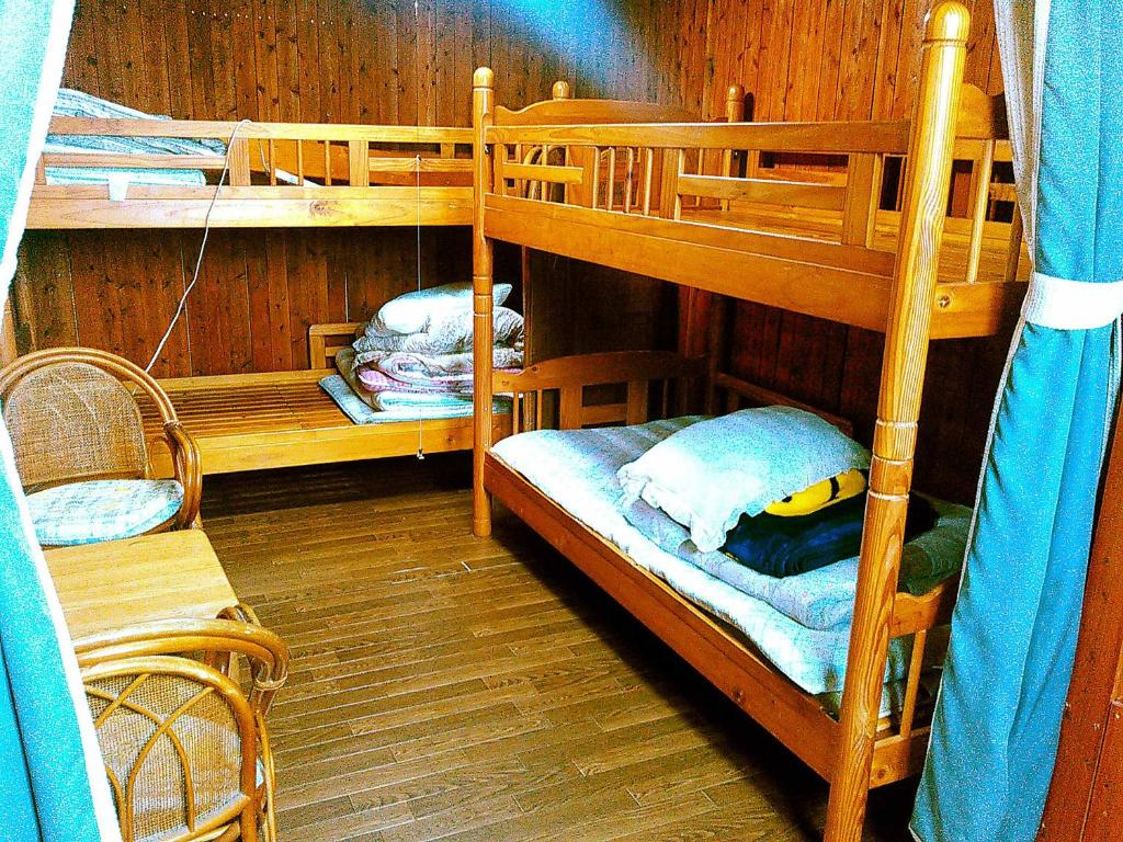 a room with two bunk beds in a room at Guest House Miyakojima in Miyako-jima