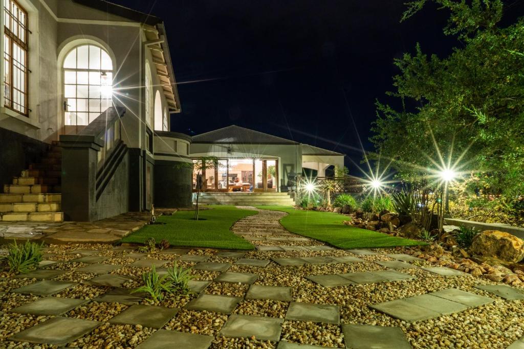 a house at night with a walkway at Haus Schwerinsburg Guest House in Windhoek