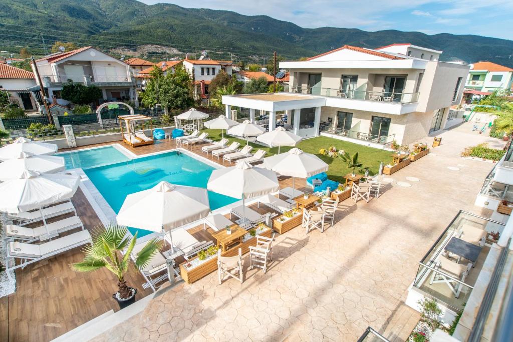 an image of a resort with a swimming pool and umbrellas at Lagaria Hotel II in Asprovalta