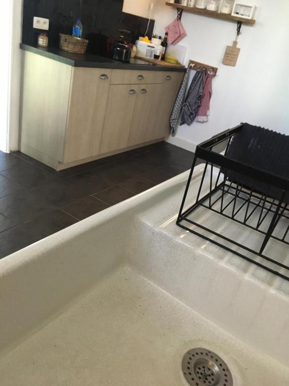 a kitchen with a bath tub and a sink at Guesthouse &#39;t Goed Leven in Stokrooie