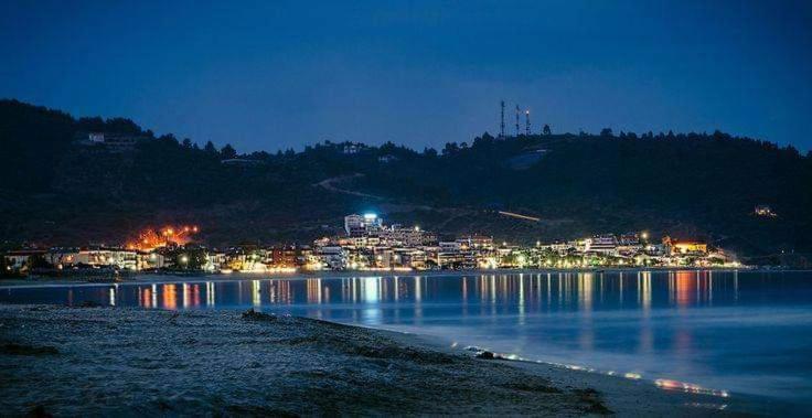 a view of a lake at night with a city at House Chrysoula Mitsokopi in Sarti