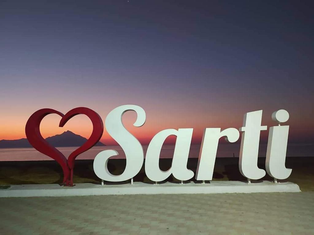 a sign that says sittin in front of a sunset at House Chrysoula Mitsokopi in Sarti