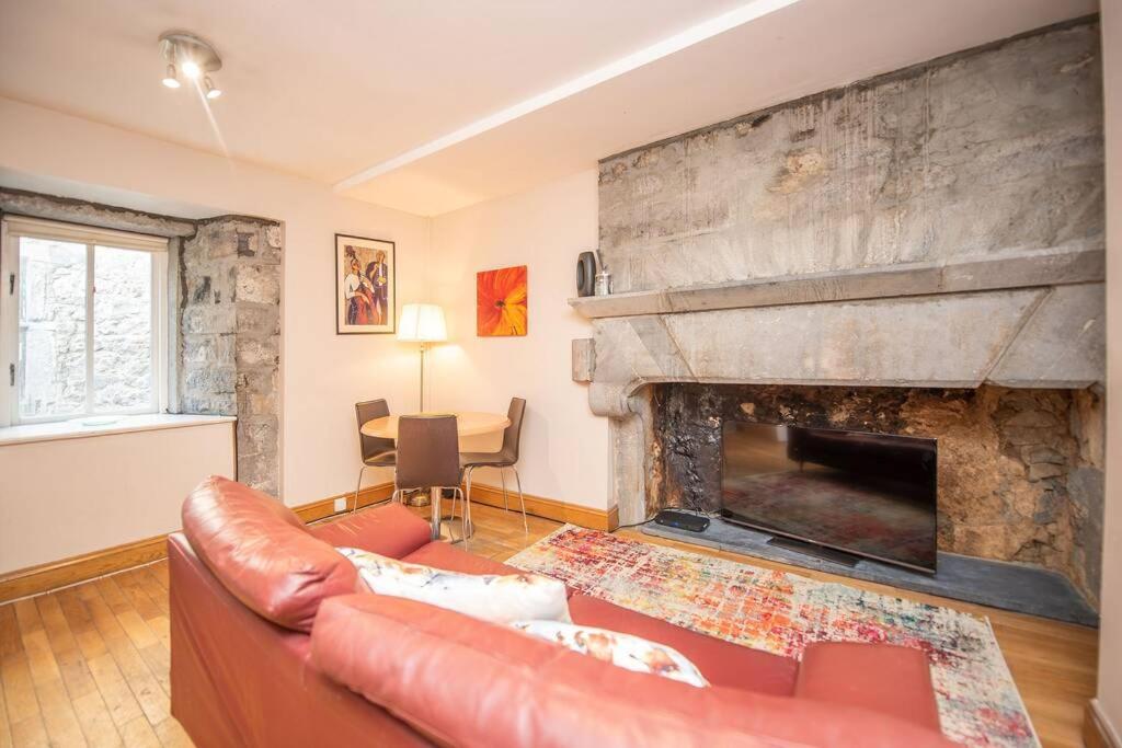a living room with a couch and a fireplace at Latin Quarter Luxury in Galway