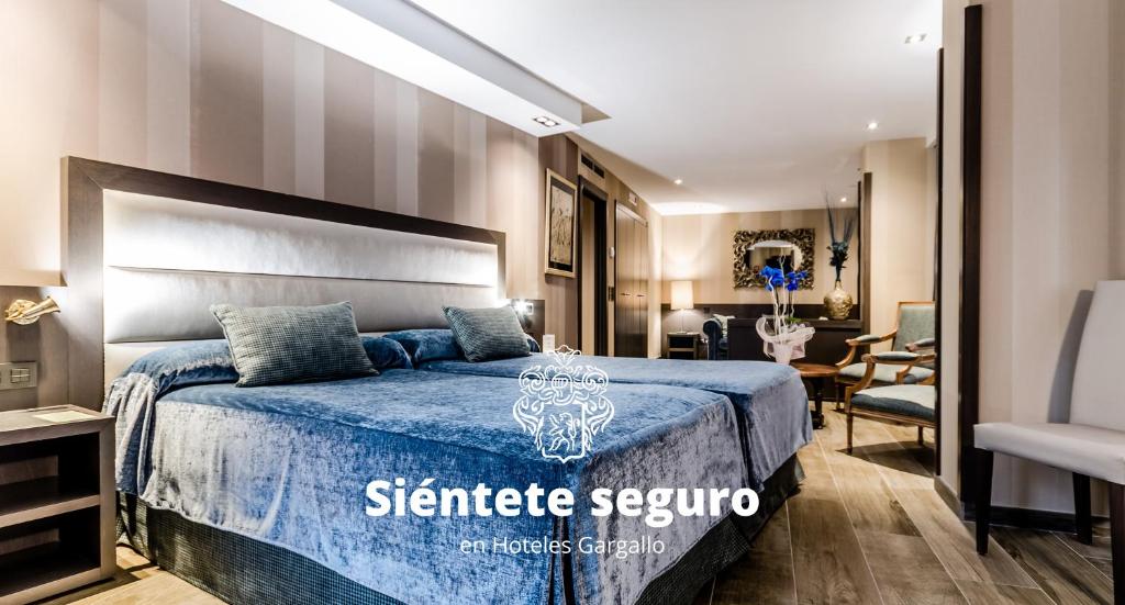 a hotel room with a bed and a desk at Reina Cristina in Teruel