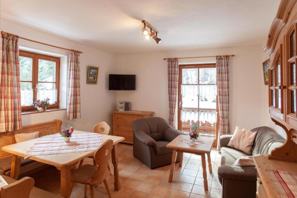 a living room with a couch and a table at Gästehaus Kurparkfrieden in Mittenwald