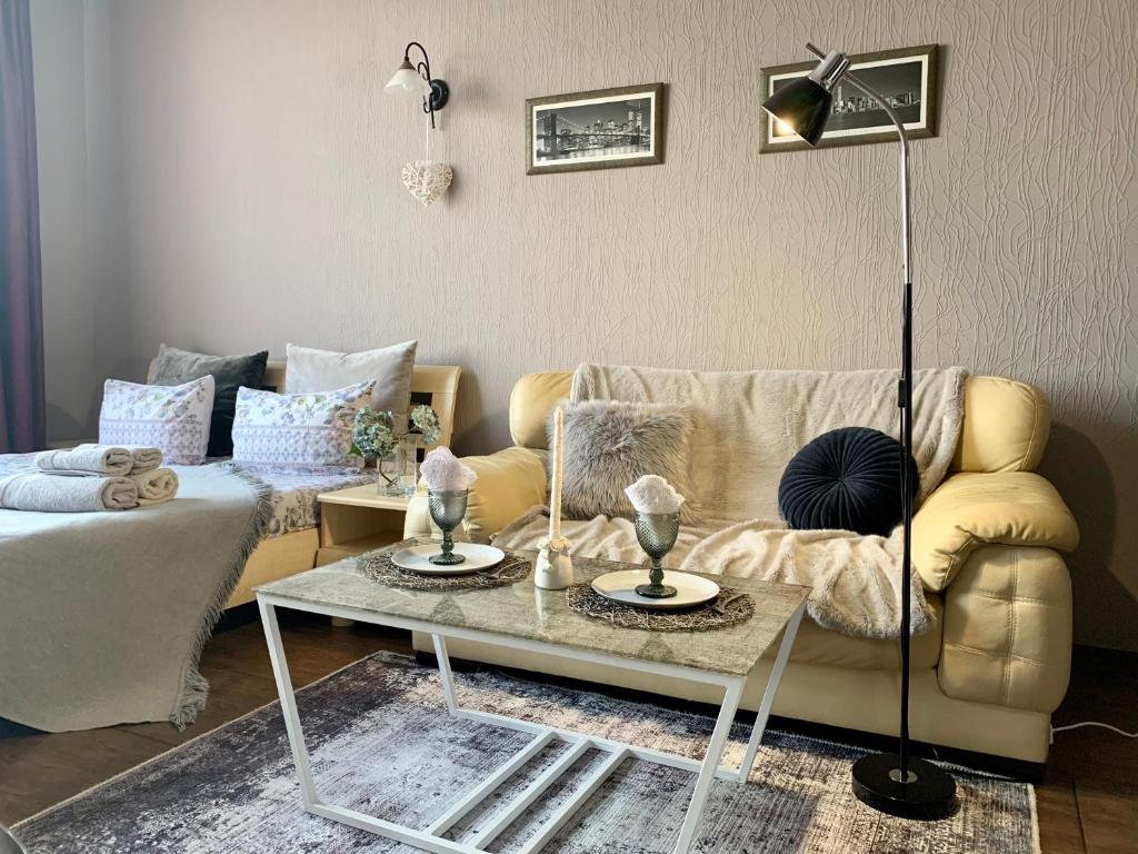 a living room with a couch and a table at Apartment Alla in Chernihiv