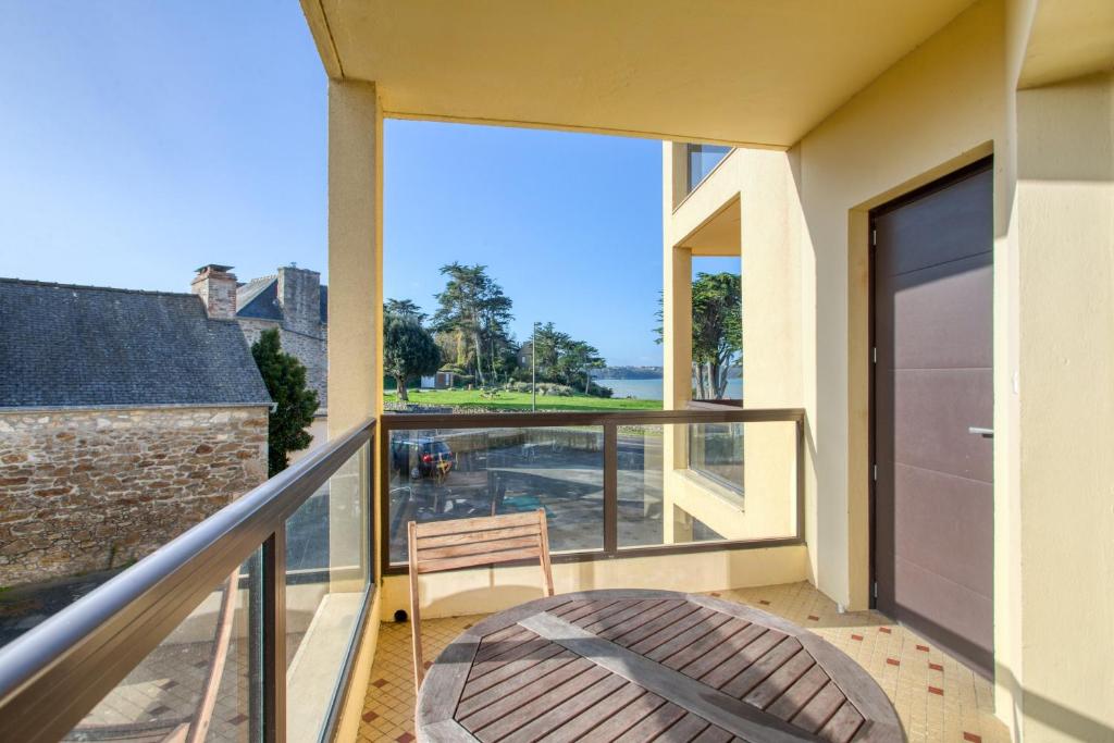 a balcony with a chair and a view of the water at Appartement de 2 chambres avec terrasse et wifi a Saint Jacut de la Mer in Saint-Jacut-de-la-Mer