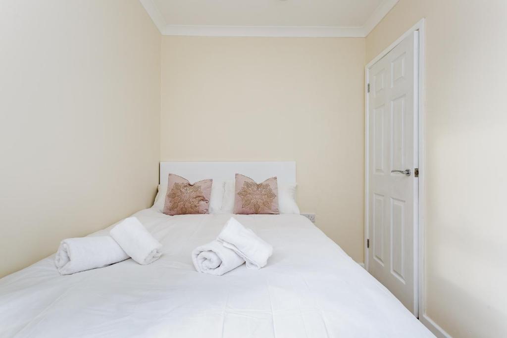 a bedroom with a white bed with pillows at Blackberry - Stylish Self-Contained Flats in Soton City Centre in Southampton