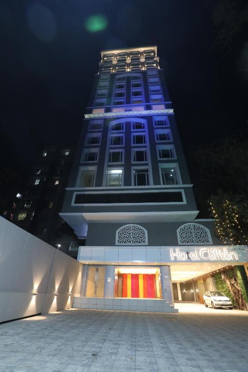 a tall building with a blue light on it at Hotel Cliffton in Mumbai