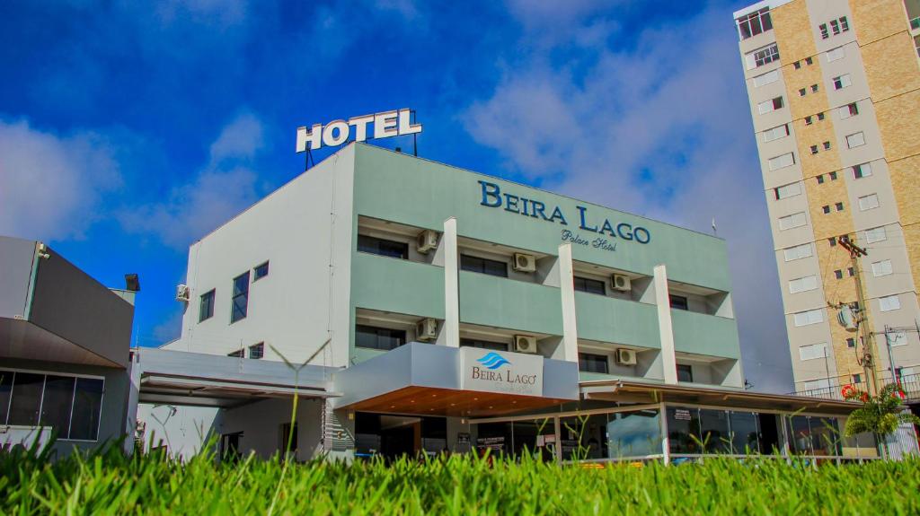 a hotel in front of a tall building at Beira Lago Palace Hotel in Morrinhos