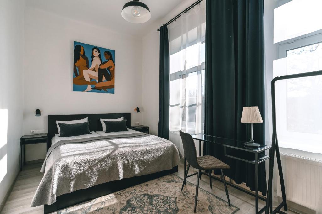 a bedroom with a bed and a chair and a window at Brother House Kaunas in Kaunas