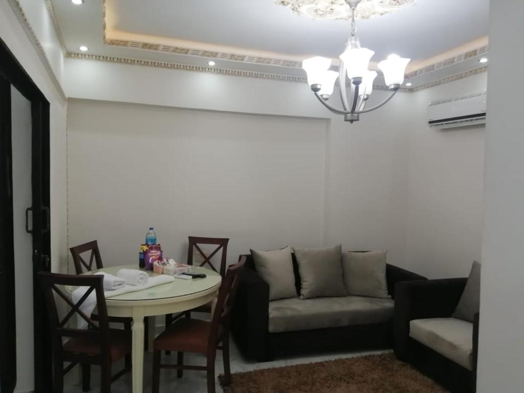 a living room with a couch and a table at Saraya Eltram-families only in Alexandria