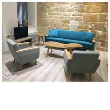 ein Wohnzimmer mit einem blauen Sofa und 2 Stühlen in der Unterkunft Marais, 2 pièces luxueux rénové, près rue Bretagne in Paris