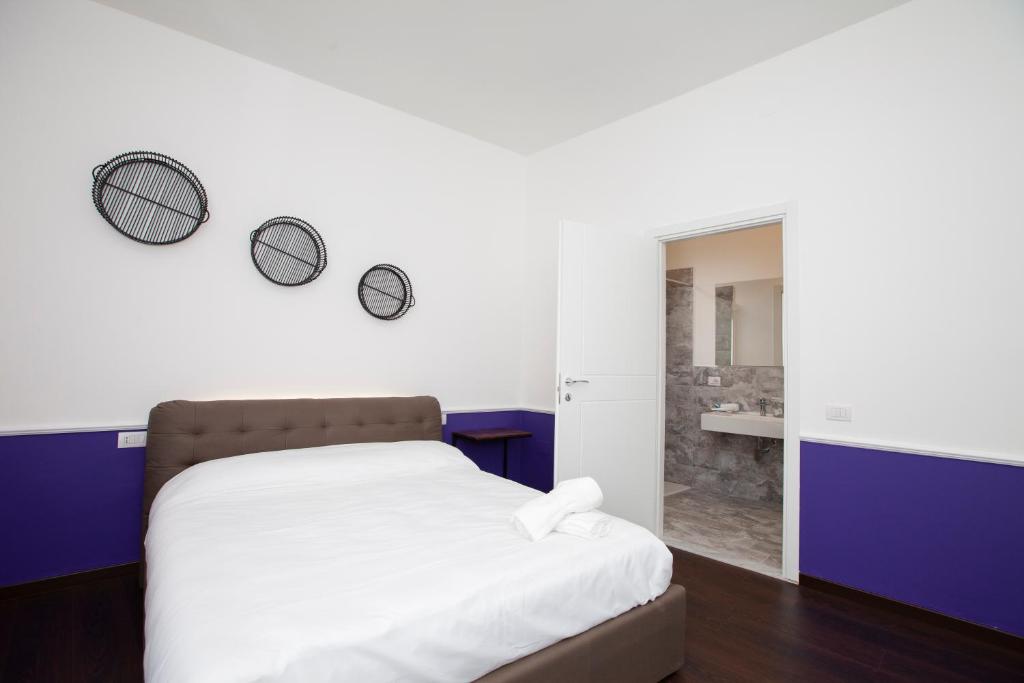 Łóżko lub łóżka w pokoju w obiekcie Myrtus Guest House Cagliari