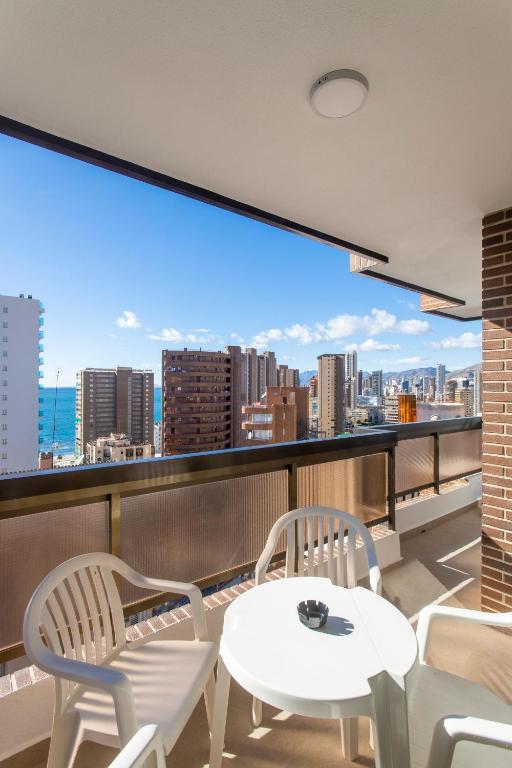 a balcony with two chairs and a table and a view at Aparthotel BCL Levante Club in Benidorm