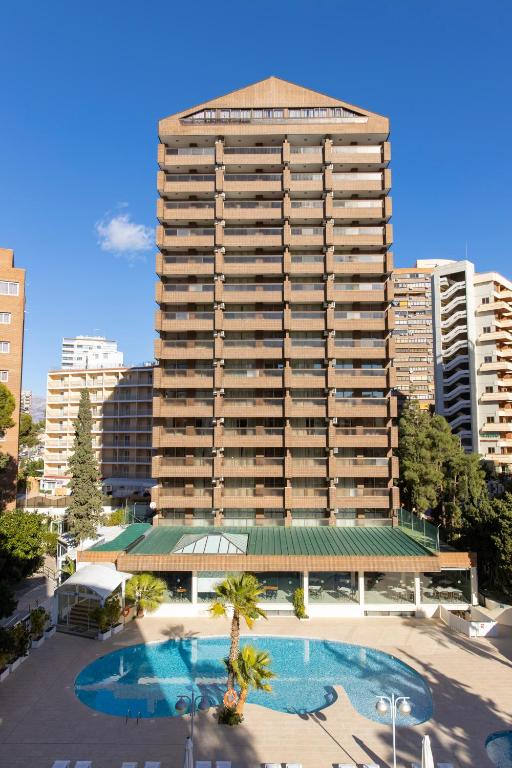 a large building with a pool in front of it at Aparthotel BCL Levante Club in Benidorm