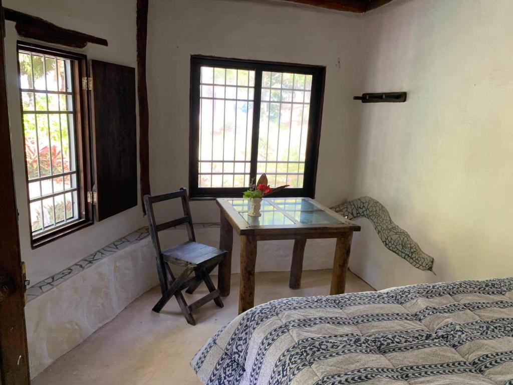 Postel nebo postele na pokoji v ubytování Chez Gigi - Eco Lodge
