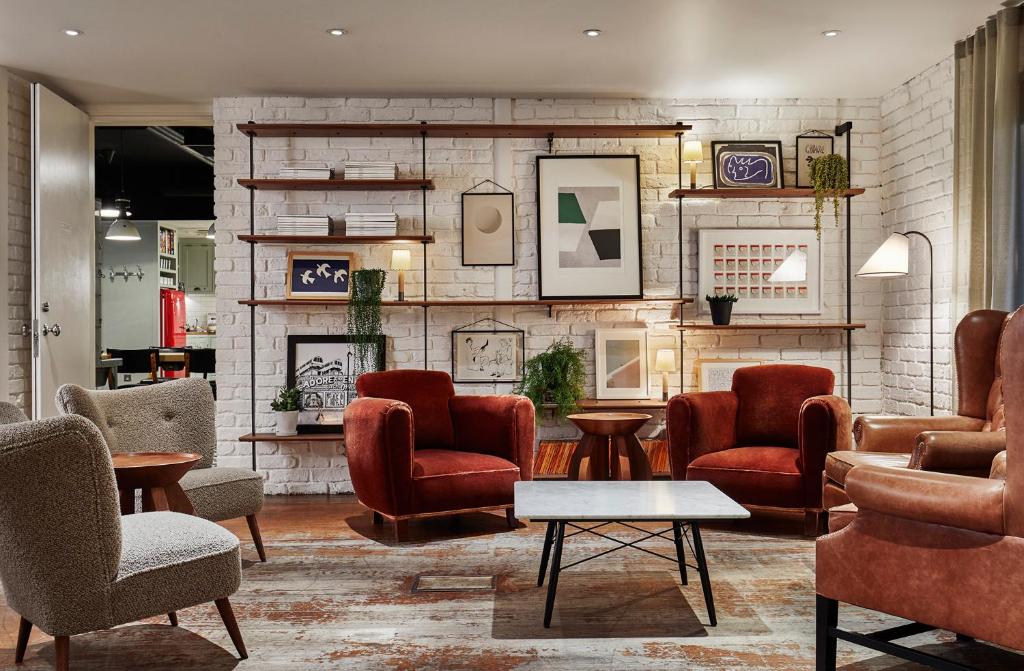 a living room filled with furniture and a coffee table at The Hoxton, Shoreditch in London