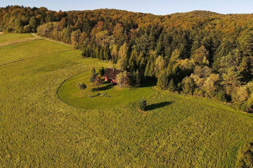 an aerial view of a house in the middle of a field at Znam Ten Widok - Bieszczady in Ustrzyki Dolne