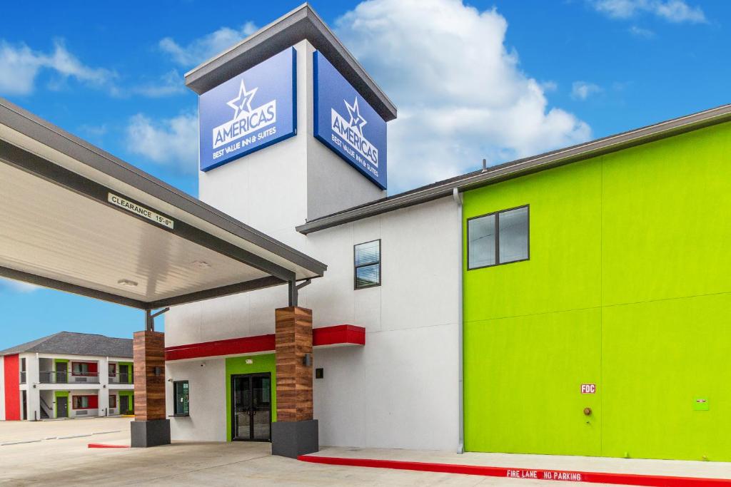 a mobil gas station with a green and white building at Americas Best Value Inn & Suites Kingwood IAH Airport in Kingwood