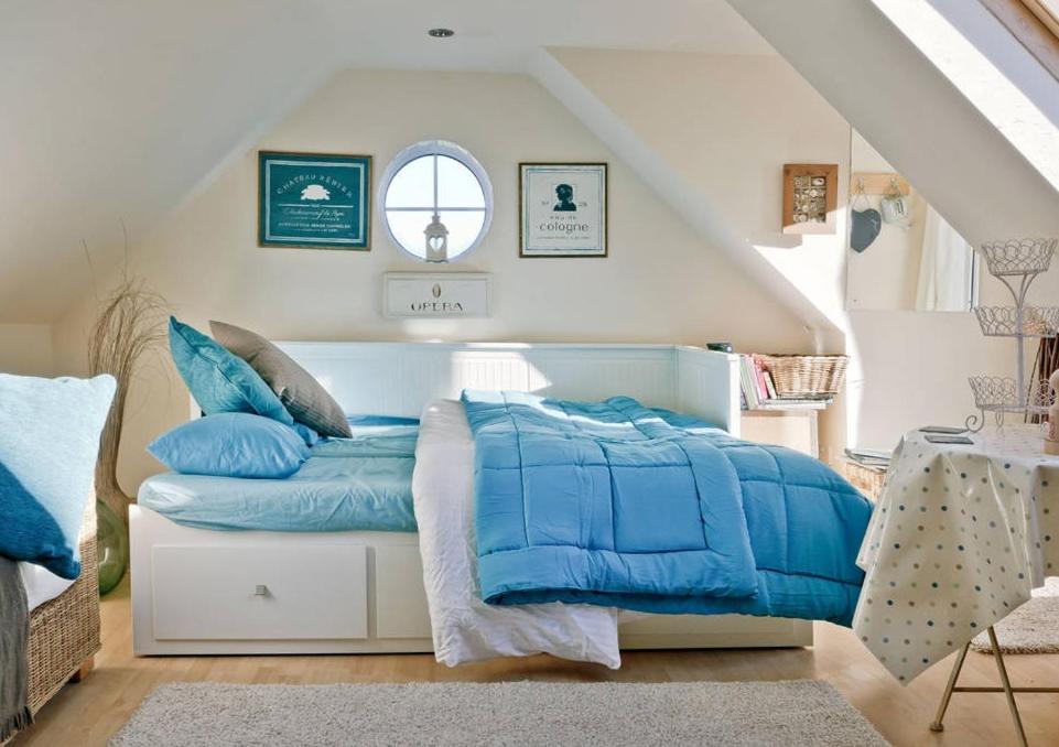 a bedroom with a bed with blue pillows on it at Robins Nest - A great place to Explore! 