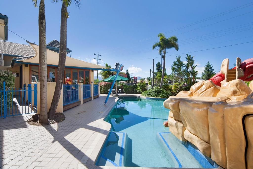 a pool at a resort with a roller coaster at Cairns Southside International in Cairns