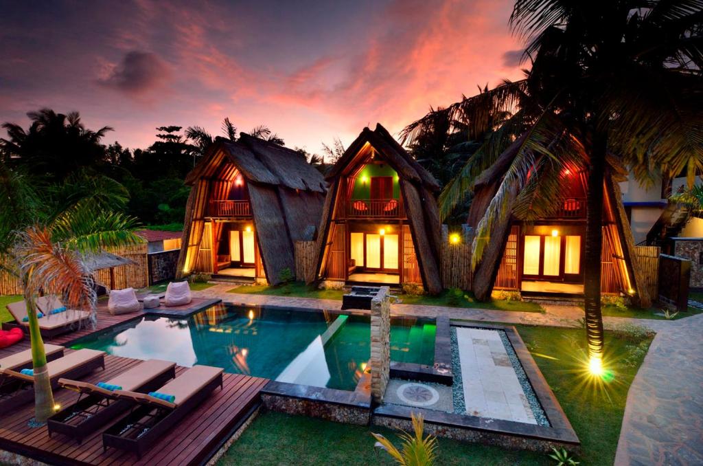 a villa with a pool and a resort at Kies Villas Lombok in Kuta Lombok