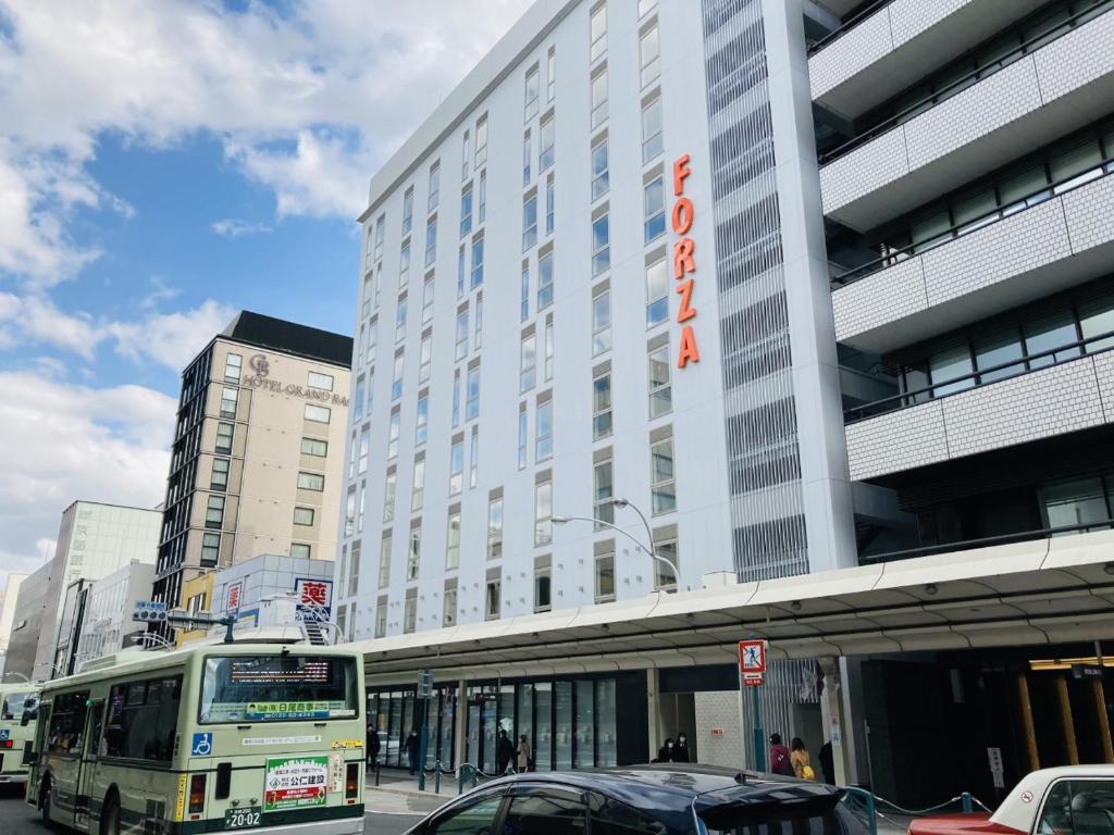 a bus is parked in front of a building at Hotel Forza Kyoto Shijo Kawaramachi in Kyoto