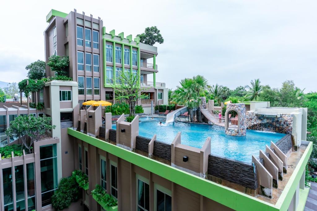 a view of a resort pool with a slide at Long Beach Cha-Am Hotel in Cha Am