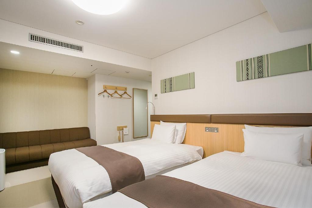 a hotel room with two beds at Mars Garden Hotel Hakata in Fukuoka